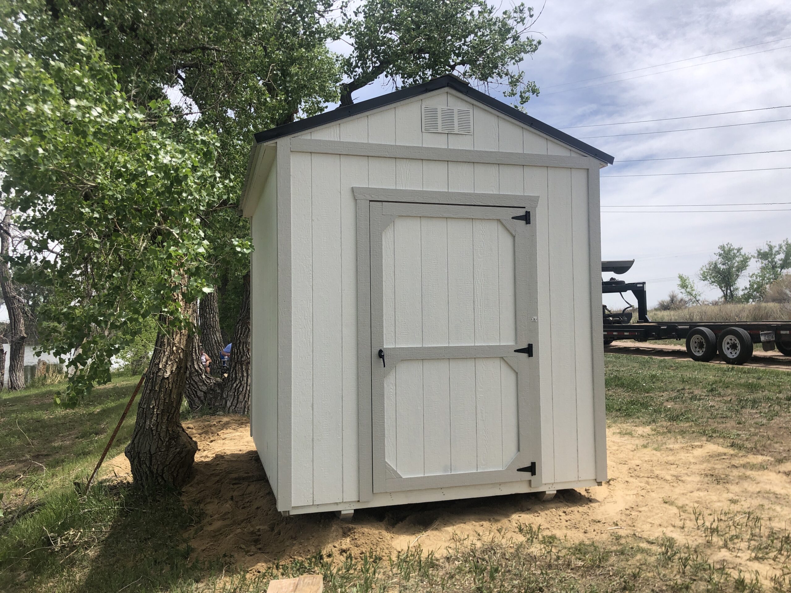 an 8X10 Shed painted in white with light grey trim